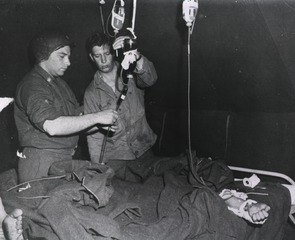 [Medical Officer administers whole blood to wounded GI at the 128th Evacuation Hospital, France]