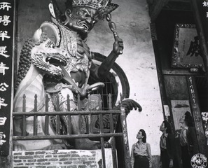 [Army nurses stand before giant guardian God of Buddhist Temple of the Western Hills, Kunming, China]