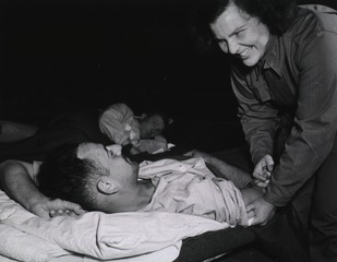[Army Nurse Lt. Gertrude A. Nolan giving patient an injection]