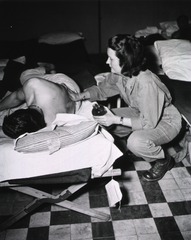 [Army Nurse Lt. Sally Anders gives patient a back rub]