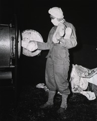 [Army Nurse Lt. Helen Flippe sterilizing surgical instruments in a protable autoclave]