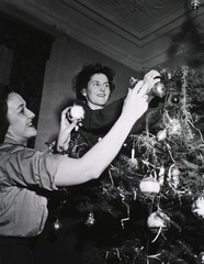 [Army Nurses trimming a Christmas tree]
