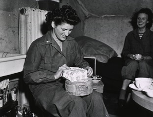 [Army Nurse 1st Lt. Edna Parker opens Christmas packages]