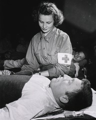 [Army Nurse checks patient]