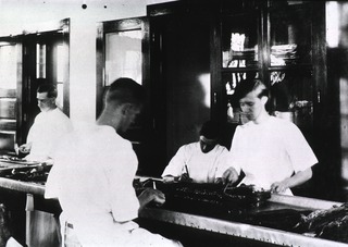 [Lab workers preparing captured rats for examination, New Orleans, La.]