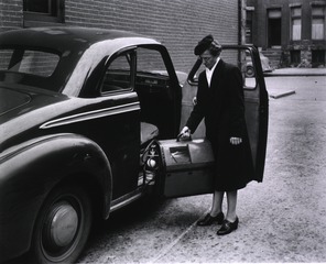 [Nurse-midwife Sara Fetter demonstrates putting the Premature Infant Carrier in the car]