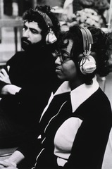 [A man and a woman wearing headsets]