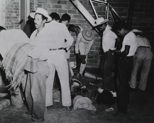 A group of [Mexican] workers dressing after their medical examination