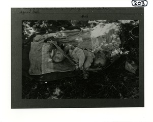 Baby of agricultural family camped by the roadside