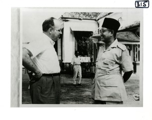 [President Sukarno of Indonesia talks with Roy Fritz, a USPHS officer]