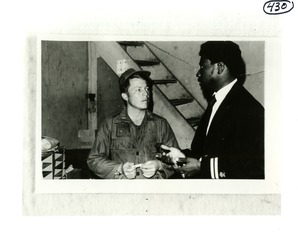 Mr. James Moore and a U.S. soldier conferring