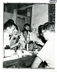 [Dr. Mackler displays instruments and drugs for group of Vietnamese]