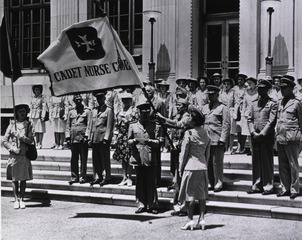 [Presentation of the Cadet Nurse Corps flag to Nurse Director Lucile Petry by Surgeon General Thomas Parran at ceremonies in Washington, D.C., in June 1944]
