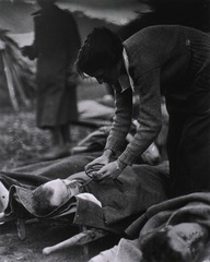 U.S. Army Evacuation Hospital Nos. 6 & 7, Souilly, France: Red Cross Worker Miss Anna Rochester, of the Smith College Unit, feeding wounded soldier through a tube