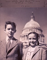 [A boy and girl, half-length portrait, standing in front of the U.S. Capitol dome]