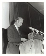 Photograph of Francis Crick lecturing in Mainz, Germany, looking down at his lectern