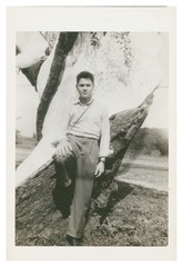 Daniel Nathans as teenager, leaning on tree stump
