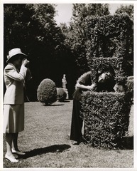 Mary Lasker taking a picture in her garden with Mrs. Alice Fordyce