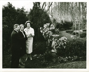 Mary Lasker with two people in a garden
