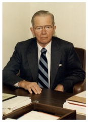 Clarence Dennis seated at his desk