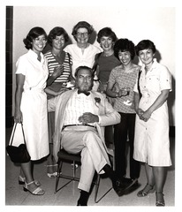 C. Everett Koop posing with female nurses and staff at an employee tea on the occasion of his retirement from the Children's Hospital of Philadelphia