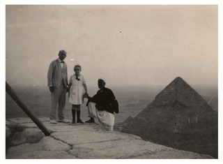 Wilbur A. Sawyer, daughter Peggy, and their guide on top of the first pyramid at Giza, Egypt