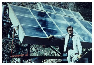 Henry Swan standing by his home's solar panels
