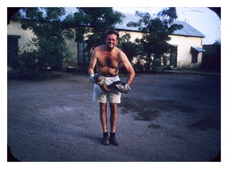Henry Swan holding a lungfish in Kampala, Uganda