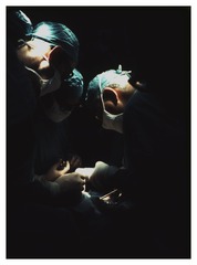 Surgeons working over baby