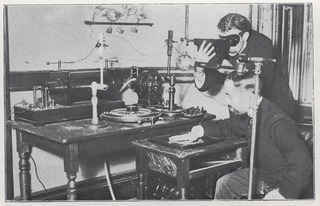 [Photograph of two men operating X-ray equipment]