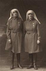 [Two nurses standing in uniform]