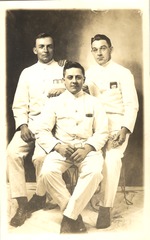 [Three men in white uniforms]