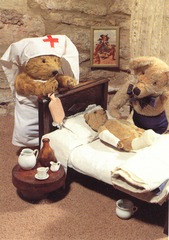 [Teddy bears dressed as a nurse, a doctor, and a patient]