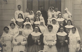[Medical staff standing together in front of a building]