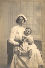 [Nurse with a baby on her lap]