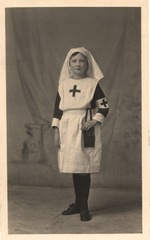 [Child dressed as a nurse with pouch containing scissors]