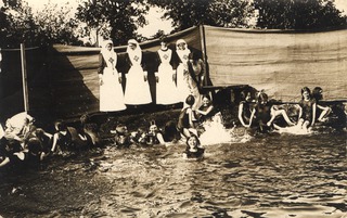 [Nurses monitoring young girls swimming in lake]