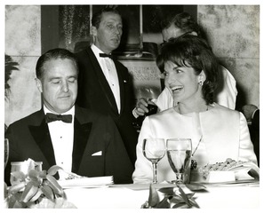 [First Lady Jacqueline Kennedy seated at table with guest]
