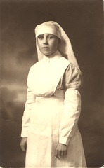 [Portrait of a young nurse]: [long white uniform and veil]