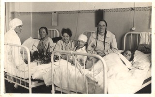 [Nurses sitting with female patients]