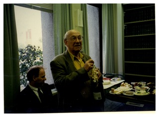 Louis Sokoloff preparing to open champagne bottle at this 75th birthday party