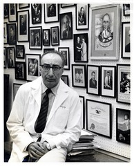 Michael DeBakey, in his office, with wall of awards and commendations behind him