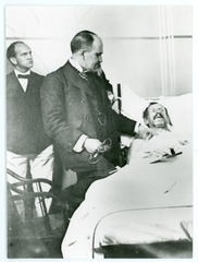 William Osler at a patient's bedside with stethoscope in hand