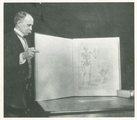 William Osler holding Vesalius' "Tabulae Anatomicae Sex" in the Bodleian Library